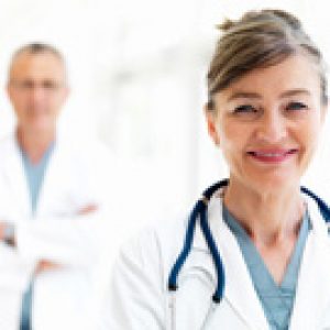 Smiling female doctor with colleague in background